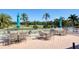 Community outdoor seating area overlooks the golf course and features dining sets with sun umbrellas at 945 Chickadee Dr, Venice, FL 34285