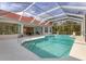 Home featuring a private pool with a screened-in lanai at 945 Chickadee Dr, Venice, FL 34285