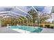 Beautiful pool and spa surrounded by a screened-in lanai at 945 Chickadee Dr, Venice, FL 34285