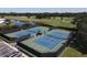 Aerial view of well-maintained community tennis courts next to the golf course at 945 Chickadee Dr, Venice, FL 34285