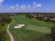 Expansive aerial view of a beautiful golf course with lush green fairways, sand traps and palm trees at 101 S Gulfstream Ave # 15H, Sarasota, FL 34236