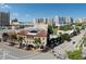 Captivating building on a tree-lined street with sidewalks, clear skies, and bright sunlight at 101 S Gulfstream Ave # 15H, Sarasota, FL 34236