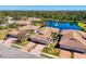 Aerial view showcases tiled-roof homes near serene lake with fountain at 1022 Yosemite Dr, Englewood, FL 34223