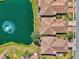An aerial view shows the pond, manicured lawns, and tiled roofs of this well-maintained community at 1022 Yosemite Dr, Englewood, FL 34223
