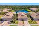 Aerial view showcases tiled-roof homes near serene lake with fountain at 1022 Yosemite Dr, Englewood, FL 34223