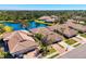 Beautiful tiled-roof homes, serene lake, and lush landscaping in an aerial view at 1022 Yosemite Dr, Englewood, FL 34223