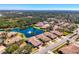 Serene community featuring tiled-roof homes surrounding a scenic lake and fountain at 1022 Yosemite Dr, Englewood, FL 34223