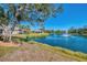 Picturesque backyard view of home along the tranquil lake with fountain at 1022 Yosemite Dr, Englewood, FL 34223