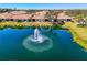 Lakefront backyard view with soothing fountain feature and lush green space at 1022 Yosemite Dr, Englewood, FL 34223