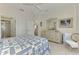 Bedroom features ensuite bathroom and light colored dresser and side chair at 1022 Yosemite Dr, Englewood, FL 34223