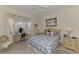Cozy bedroom with a blue and white quilt, a bay window, and soft decor at 1022 Yosemite Dr, Englewood, FL 34223