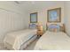 Bright bedroom featuring twin beds with matching decor, complemented by light walls and artwork at 1022 Yosemite Dr, Englewood, FL 34223