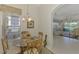 Charming dining area with glass table, views into the living room, and bright window at 1022 Yosemite Dr, Englewood, FL 34223