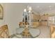 Dining area with a glass table and decorative chairs, adjoins the kitchen at 1022 Yosemite Dr, Englewood, FL 34223