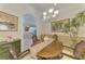 Elegant dining room showcasing art and plants, offering a glimpse into the adjacent living space at 1022 Yosemite Dr, Englewood, FL 34223