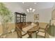 Formal dining area featuring a chandelier, elegant table setting, and ample natural light at 1022 Yosemite Dr, Englewood, FL 34223
