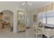 Light-filled entryway featuring a decorative dresser, white-tile flooring, and a desk at 1022 Yosemite Dr, Englewood, FL 34223