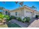 Beautiful villa with a two-car garage, manicured landscaping, and brick paved walkway at 1022 Yosemite Dr, Englewood, FL 34223