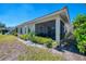Charming exterior view of the home, showcasing a screened patio and lush landscaping at 1022 Yosemite Dr, Englewood, FL 34223