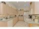 Kitchen with neutral cabinets, tile backsplash, stainless sink and appliances at 1022 Yosemite Dr, Englewood, FL 34223