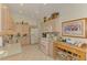 Bright kitchen features light colored cabinets, tile backsplash and stainless steel sink at 1022 Yosemite Dr, Englewood, FL 34223