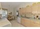 Kitchen with stainless steel sink and light colored cabinets flows into dining area at 1022 Yosemite Dr, Englewood, FL 34223