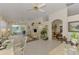Bright living area with tiled floors, neutral decor, and a glimpse into the dining room at 1022 Yosemite Dr, Englewood, FL 34223
