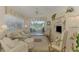 Comfortable living room with sliding glass doors leading to a patio and a tranquil lake view at 1022 Yosemite Dr, Englewood, FL 34223