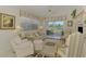 Bright living room with neutral decor, large windows, and a sliding door to a patio at 1022 Yosemite Dr, Englewood, FL 34223