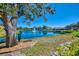 Scenic view of a pond with a fountain, framed by mature trees and lush landscaping, enhancing the serene setting at 1022 Yosemite Dr, Englewood, FL 34223