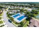 Aerial view showcasing pristine blue tennis courts surrounded by lush landscaping in the community at 1022 Yosemite Dr, Englewood, FL 34223