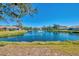 Picturesque view of the lake with a fountain, highlighting the serene community setting at 1022 Yosemite Dr, Englewood, FL 34223