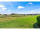Enjoy the scenic backyard view with lush green grass and a tranquil pond behind these homes at 1050 Jonah Dr, North Port, FL 34289