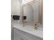 Well-lit bathroom with elegant mirror, spacious countertop, and a sleek sink with modern fixtures at 1050 Jonah Dr, North Port, FL 34289