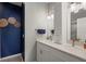 Modern bathroom with double sink vanity, stylish fixtures, and a well-lit mirror on a beautiful wall at 1050 Jonah Dr, North Port, FL 34289