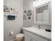 Bathroom showcasing vanity, framed mirror, decorative wall art, and a toilet with paper roll at 1050 Jonah Dr, North Port, FL 34289