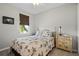 Bright bedroom with a comfortable bed, brown shade on the window, and a charming nightstand with lamps at 1050 Jonah Dr, North Port, FL 34289