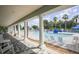 Resort-style pool features bright lounge seating, shaded veranda, and a sun-soaked lounging area at 1050 Jonah Dr, North Port, FL 34289