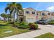 Charming two-story home with a well-manicured lawn, lush landscaping, and a spacious driveway leading to an attached garage at 1050 Jonah Dr, North Port, FL 34289