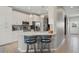 Bright kitchen features white cabinetry, stainless steel appliances, and a stylish breakfast bar with seating at 1050 Jonah Dr, North Port, FL 34289