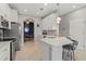 Well-equipped kitchen with stainless steel appliances, white cabinets, a breakfast bar, and convenient access to the adjacent dining area at 1050 Jonah Dr, North Port, FL 34289
