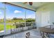 Screened-in lanai with seating, small bar tables and views of landscaping and a pond at 1050 Jonah Dr, North Port, FL 34289