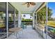 Inviting screened-in lanai with comfortable seating, bar tables and views of lush greenery at 1050 Jonah Dr, North Port, FL 34289