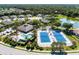 Aerial view featuring community pool and tennis courts surrounded by well-maintained landscaping and residences at 1056 Topelis Dr, Englewood, FL 34223