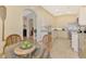 Kitchen featuring arched doorway and white cabinetry at 1056 Topelis Dr, Englewood, FL 34223