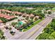 Scenic aerial view of the neighborhood, highlighting the community pool, nearby roads, and tree coverage at 1088 Bluffwood Dr, Nokomis, FL 34275