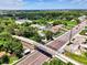 Overhead view of neighborhood highlighting pedestrian bridge and traffic thoroughfare at 1088 Bluffwood Dr, Nokomis, FL 34275