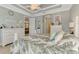 A view of the bedroom with a full view of the bed and a peek into the living room and bathroom at 1088 Bluffwood Dr, Nokomis, FL 34275