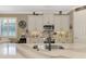 Well-equipped kitchen with stainless steel appliances, custom cabinets, and stylish backsplash at 1088 Bluffwood Dr, Nokomis, FL 34275