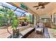Enclosed lanai with an outdoor kitchen, comfortable seating area, and lush landscaping at 1088 Bluffwood Dr, Nokomis, FL 34275